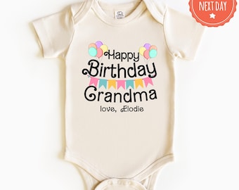 May include: A cream colored baby onesie with a graphic that says "Happy Birthday Grandma" with colorful balloons and a banner. The text "love, Elodie" is below the graphic.