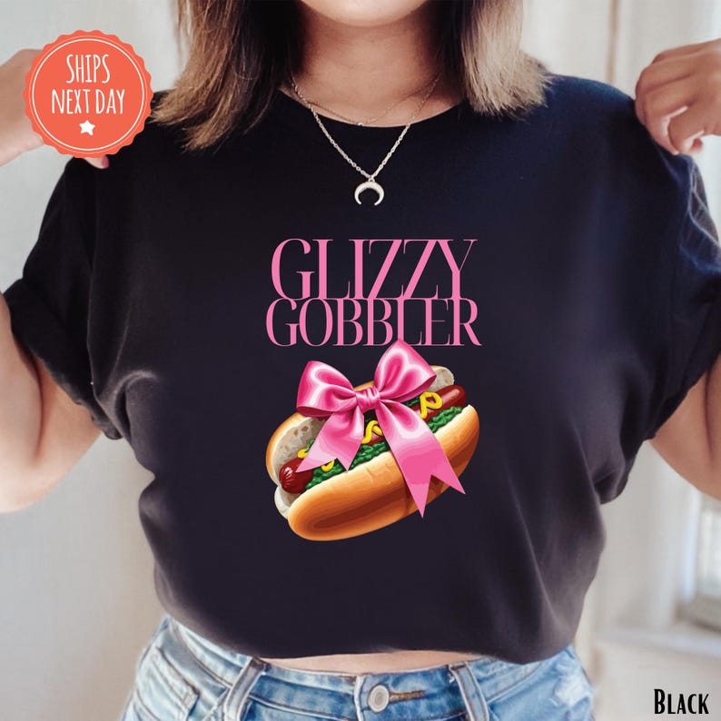 a woman wearing a black shirt with a hot dog on it