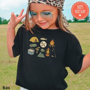 a little girl wearing sunglasses and a hat