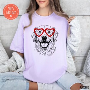 a woman wearing a t - shirt with a dog wearing heart glasses