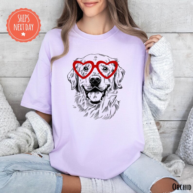 a woman wearing a t - shirt with a dog wearing heart glasses