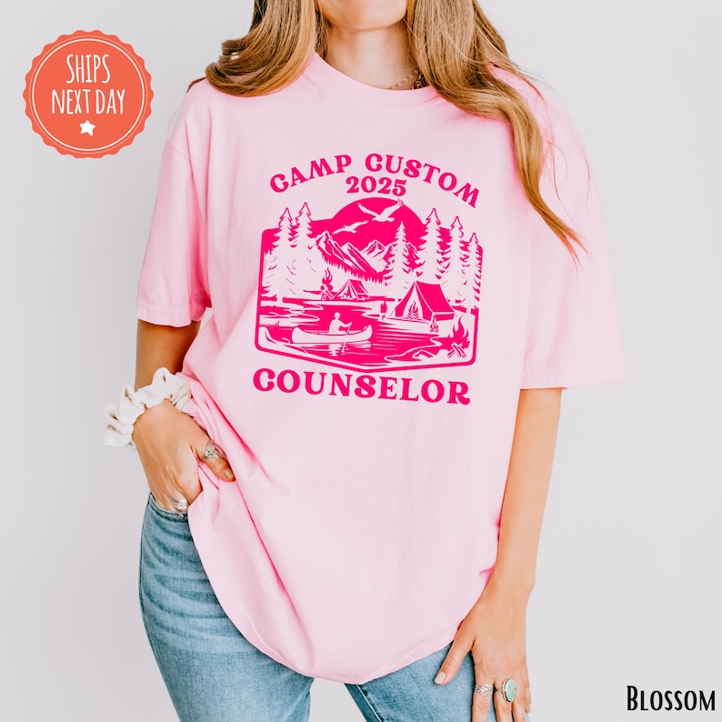 a woman wearing a pink shirt that says camp guston