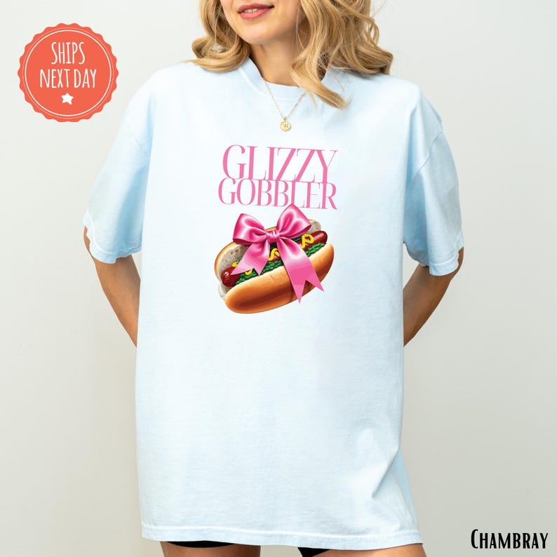 a woman wearing a blue shirt with a hot dog on it