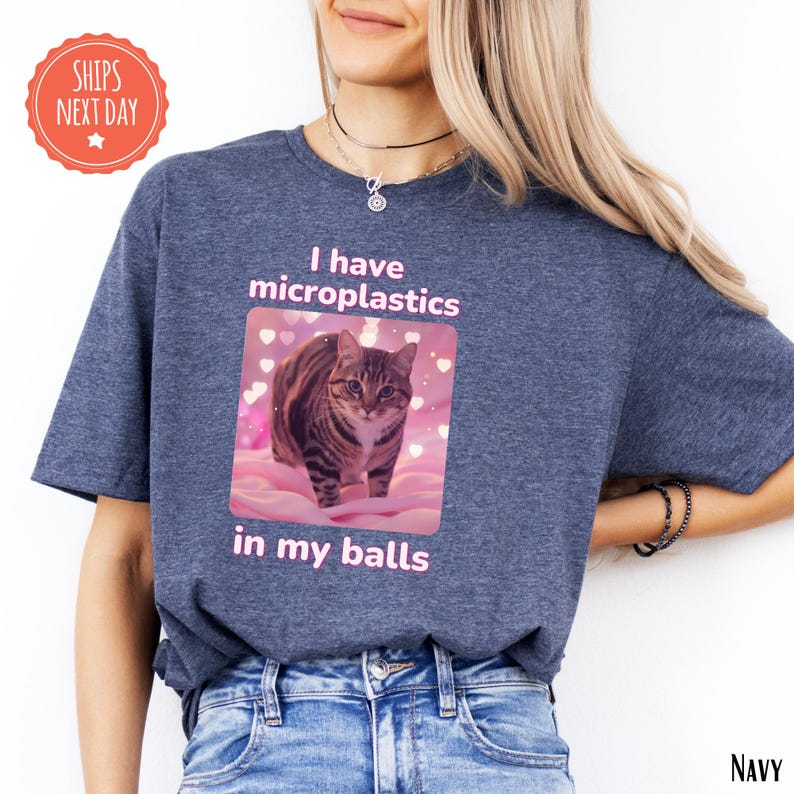 a woman wearing a t - shirt with a picture of a cat on it