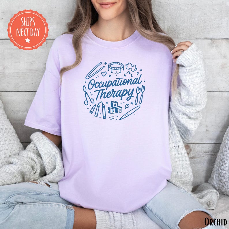 A woman wearing a purple t-shirt with the text "Occupational Therapy" printed on it, sitting on a couch.