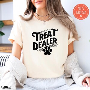 a woman wearing a t - shirt that says treat dealer