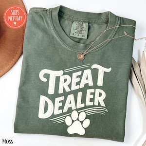 a t - shirt that says treat dealer with a dog's paw on it