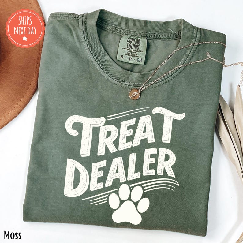 a t - shirt that says treat dealer with a dog's paw on it