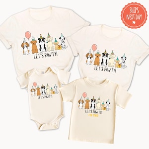 three white t-shirts with a design featuring cartoon dogs wearing party hats and the text "Let's pawty!" printed on them.