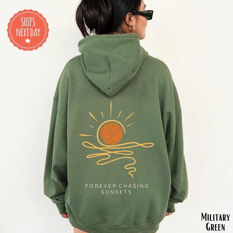 a woman wearing a green sweatshirt with a sun on it