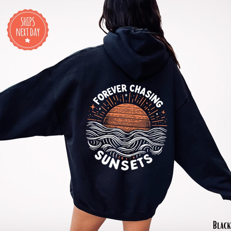 a woman wearing a black sweatshirt with the words forever chasing sunsets on it