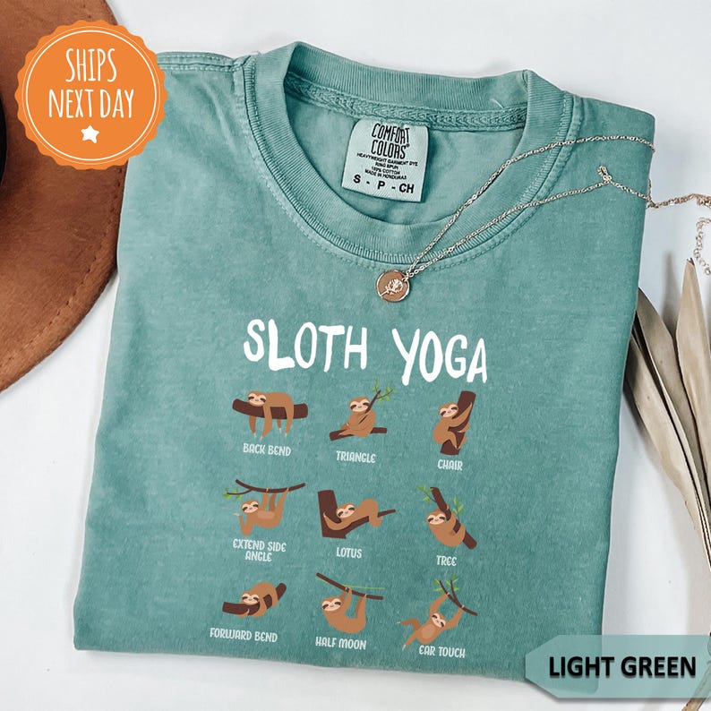 a green shirt with sloth yoga on it
