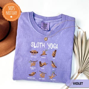 a purple shirt with sloth yoga on it
