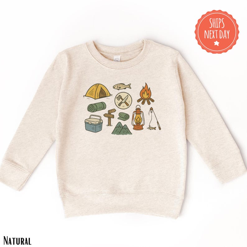 a sweater with a picture of camping items on it
