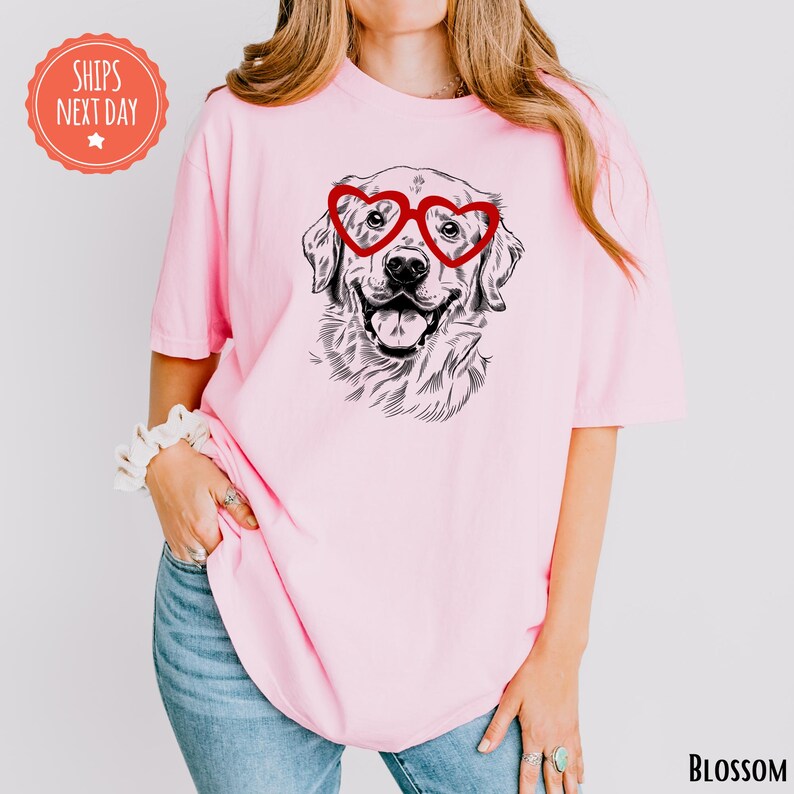 a woman wearing a pink shirt with a dog wearing glasses