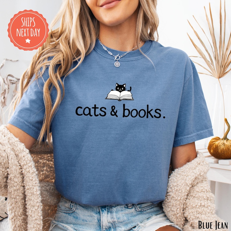 a woman wearing a cat and books t - shirt