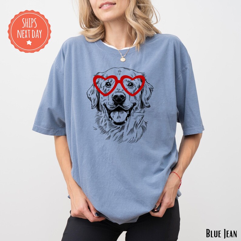a woman wearing a blue shirt with a picture of a dog wearing glasses
