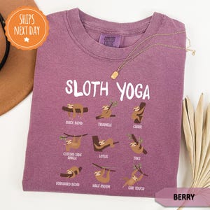 a purple shirt with sloth yoga on it