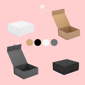 May include: Four gift boxes in different colours with magnetic closures. The boxes are white, brown, black and grey. The boxes are open and show the inside of the box. The boxes are all the same size and shape. The boxes are made of cardboard. The boxes are ideal for packaging small gifts or favours.