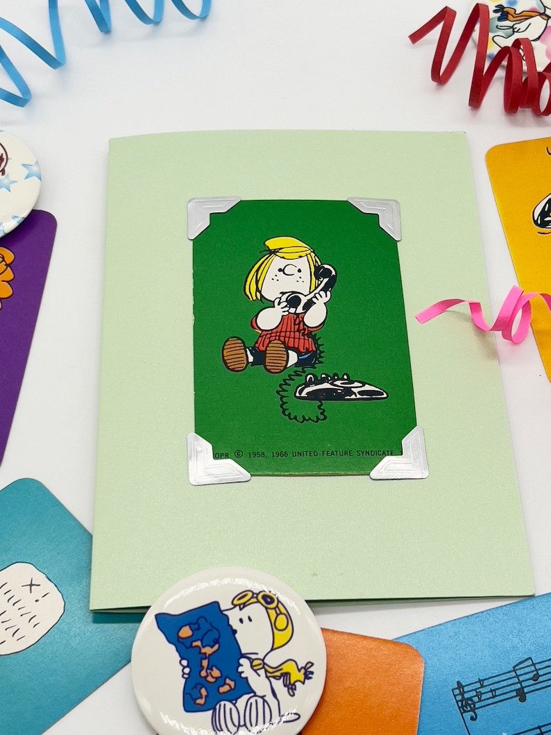 Green Peppermint patty playing card attache dot green pearlescent card. Patty is on the phone.