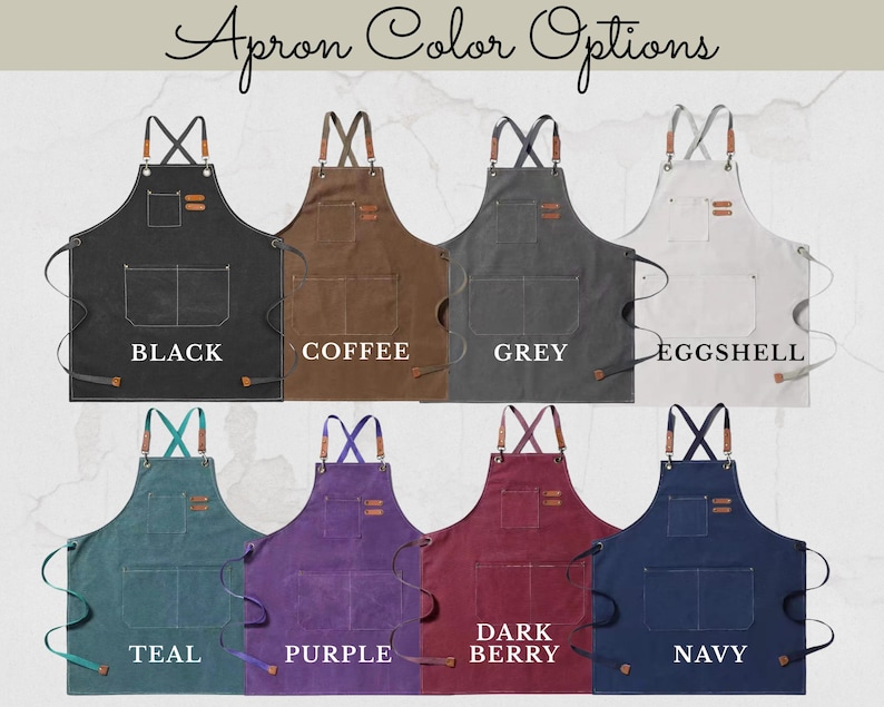 May include: Selection of aprons in black, coffee, grey, eggshell, teal, purple, dark berry, and navy. Each apron features a pocket and leather details. The text "Apron Color Options" is displayed at the top.