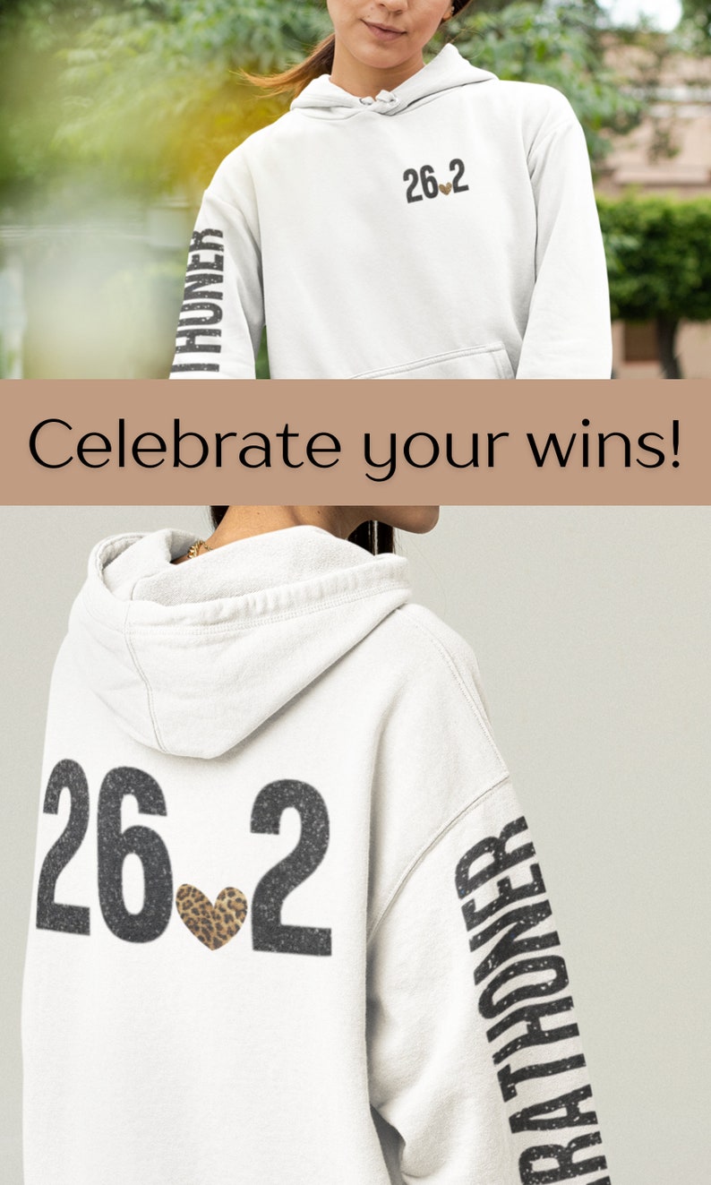May include: White hoodie with a black and white graphic of "26.2" with a leopard print heart on the back. The left sleeve has the word "Marathoner" printed vertically in black and white.