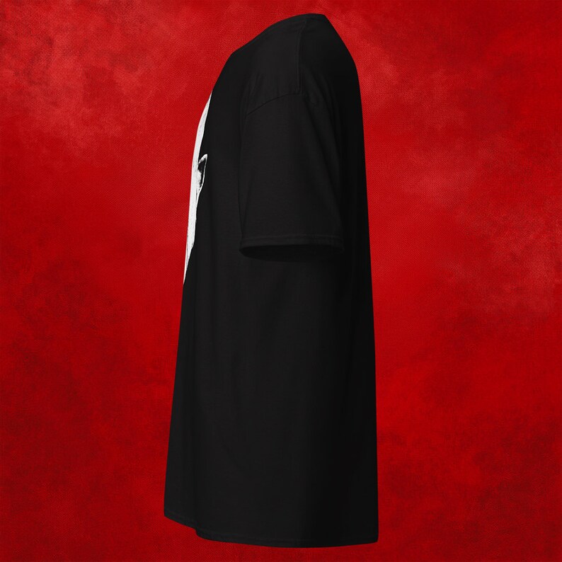 May include: A black t-shirt with a white graphic design on the front. The design is a silhouette of a person's head with a crown on top.