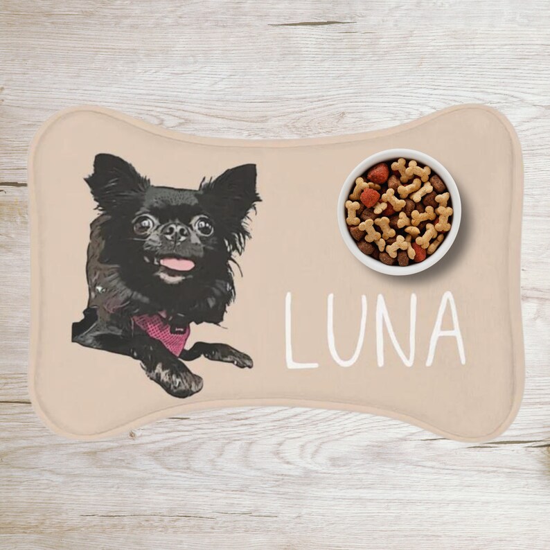 May include: A beige dog food mat with a black chihuahua illustration, a white bowl filled with dog food, and the name "LUNA" written in white.