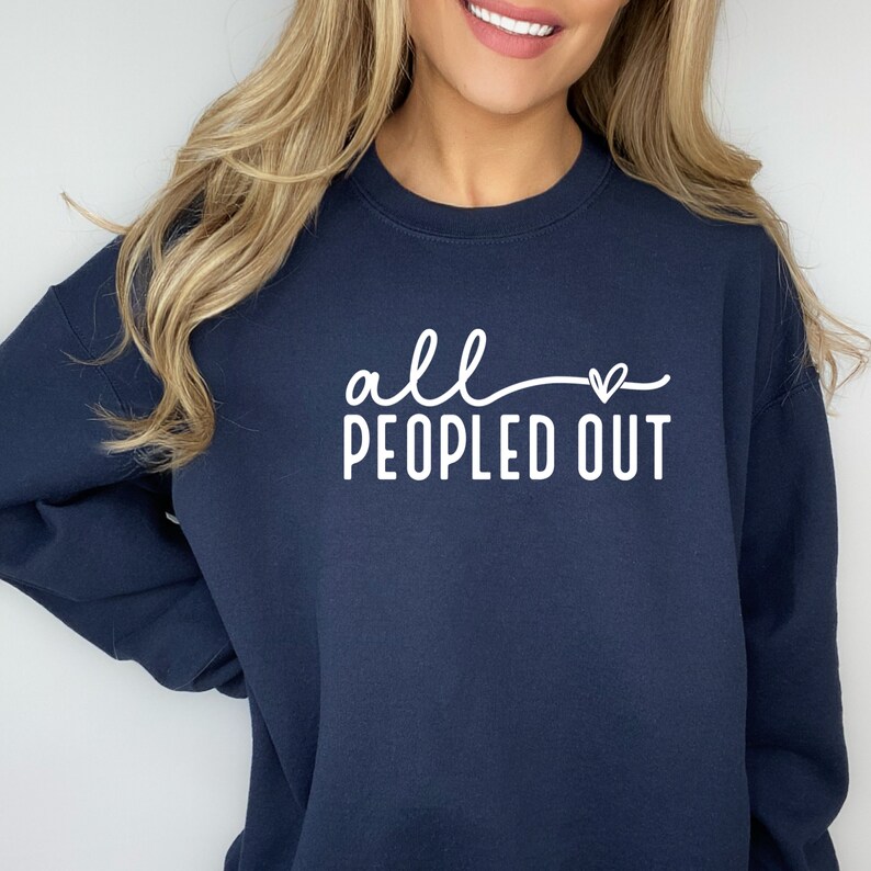May include: A navy blue sweatshirt with the text "all - heart - peopled out" in white.