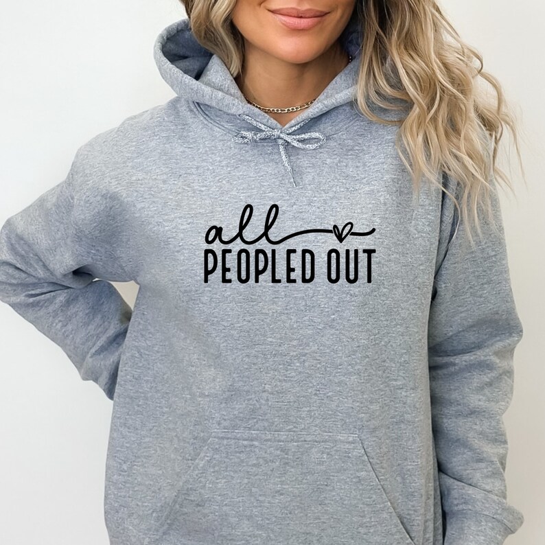May include: Gray hooded sweatshirt with the text "all peopled out" and a small heart graphic.