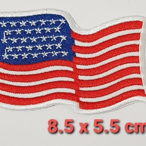 May include: An embroidered American flag patch with red and white stripes and blue stars. The patch is 8.5 x 5.5 cm.