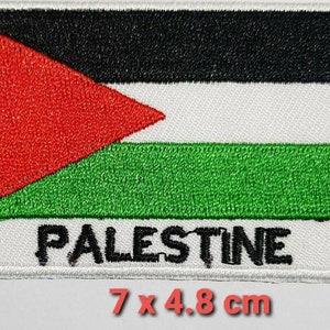 May include: An embroidered patch featuring the Palestinian flag with the word "PALESTINE" written below. The flag is black, white, green, and red. The patch measures 7 by 4.8 centimetres.