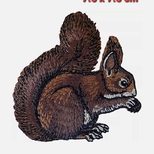 May include: Brown embroidered squirrel patch, 7.6 x 7.5 cm.