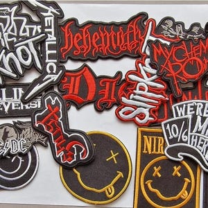 Könnte beinhalten: Eine Sammlung von Band-Patches mit verschiedenen Rock- und Metal-Bands, darunter Slipknot, Metallica, Behemoth, My Chemical Romance und Nirvana. Die Patches sind schwarz, rot, weiß und gelb mit gestickten Schriftzügen und Grafiken.