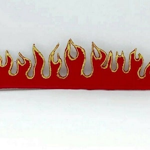 May include: Red and gold flame design patch. The flames are outlined in gold and the base is red.