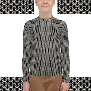 May include: A black long-sleeved shirt with a chainmail pattern. The shirt is made of a soft, comfortable material and has a mock neck.