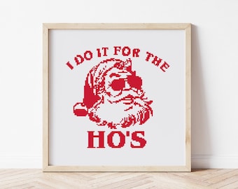 May include: A framed print with a red pixelated image of Santa Claus wearing sunglasses and the text "I do it for the ho's".