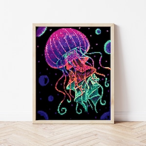 May include: A pixelated jellyfish with a pink, purple, and blue bell and green tentacles against a black background with white dots.