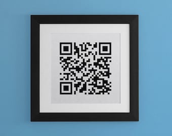May include: A black framed picture with a white mount and a black and white QR code in the centre.