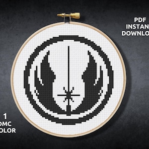May include: A black and white cross stitch pattern of the Rebel Alliance symbol from Star Wars. The pattern is in a circular embroidery hoop. The text "PDF INSTANT DOWNLOAD" is in the upper right corner of the image. The text "1 DMC COLOR" is in the lower left corner of the image.