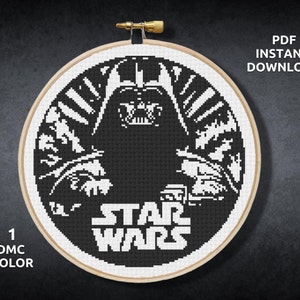 May include: Black and white cross-stitch pattern of Darth Vader from Star Wars. The pattern includes the text "Star Wars".