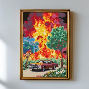 May include: A framed pixel art cross-stitch depicting a maroon sedan parked on a road before a large, vibrant explosion of yellow, orange, and red flames. The scene includes green trees and small white flowers, all rendered in a blocky, digital style.
