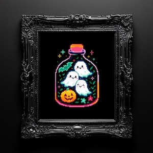 May include: A framed pixel art print with a black background and a decorative black frame. The artwork shows three friendly white ghosts in a glass bottle, a jack-o'-lantern, and other Halloween-themed elements.