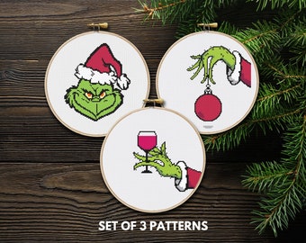 May include: Set of three cross-stitch patterns featuring the Grinch from the popular Christmas movie "How the Grinch Stole Christmas". The patterns include the Grinch wearing a Santa hat, the Grinch's hand holding a Christmas ornament, and the Grinch's hand holding a glass of wine.