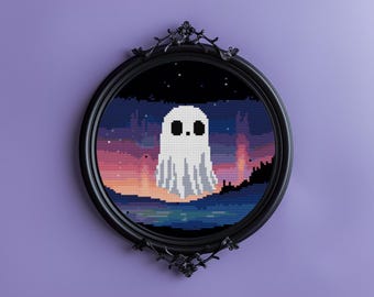 May include: A pixel art ghost in a black oval frame. The artwork features a white ghost with a simple face against a sunset sky with stars. The frame has ornate detailing and is mounted on a purple wall.