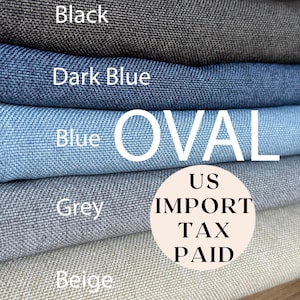 May include: A selection of fabric samples in shades of black, dark blue, blue, grey, and beige. The word "OVAL" is printed in white across the blue fabric. A circular sticker reads "US IMPORT TAX PAID".