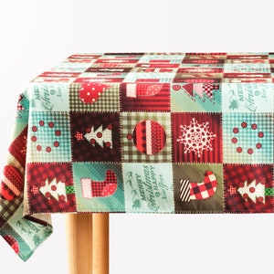 May include: A red and green Christmas tablecloth with a patchwork design featuring various holiday motifs, including Christmas trees, ornaments, snowflakes, and stockings. The text "Merry Christmas & Happy Holidays" is printed on the tablecloth.