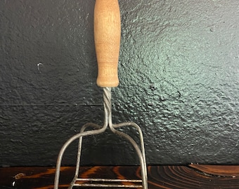 Vintage potato masher with wood handle