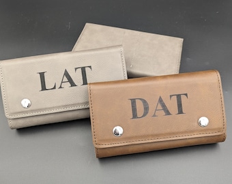 Puede incluir: Tres carteras de cuero personalizadas en gris y marrón con las iniciales "LAT" y "DAT" grabadas en la parte delantera.
