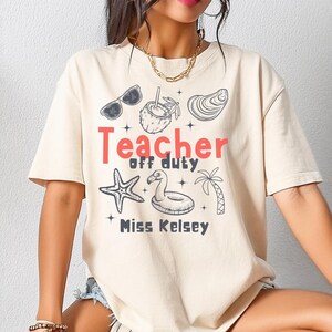 Comfort Colours Personalised Teacher Off Duty Shirt Teacher Summer Break Shirt Schools Out Summer Teacher Off Duty Beach T-Shirt with name.